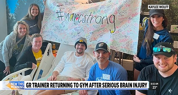 People support man in hospital after serious injury